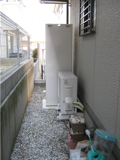 家の横の狭い通路に設置したエコキュートの貯湯タンクとヒートポンプ